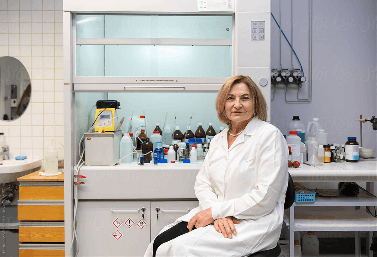 Scientist in a laboratory seated in front of equipment and chemical samples during drug research